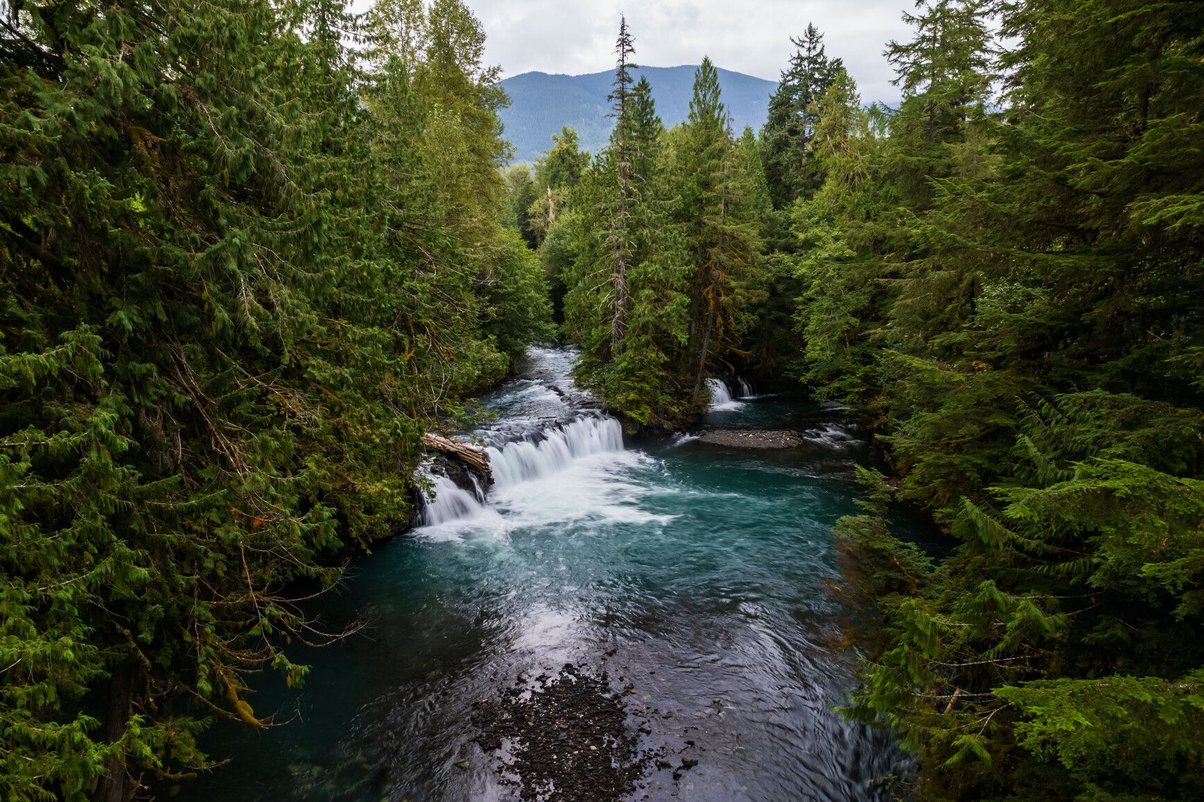 Vetter Falls in the Nass Valley, where cascading waters meet ancient volcanic terrain in Anhluut'ukwsim Lax̱mihl Angwinga'asanskwhl Nisg̱a'a Park — a serene moment in the heart of Nisg̱a'a Memorial Lava Bed Park. Courtesy of Destination BC