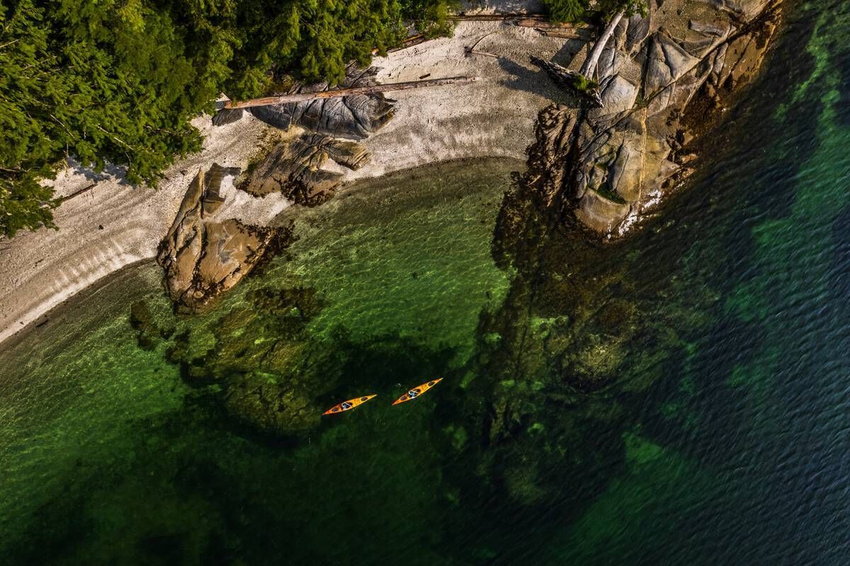 <p>Kayakers explore the serene coastline of Monkey Beach Conservancy by kayak in Bishop Bay. Courtesy Destination BC</p>