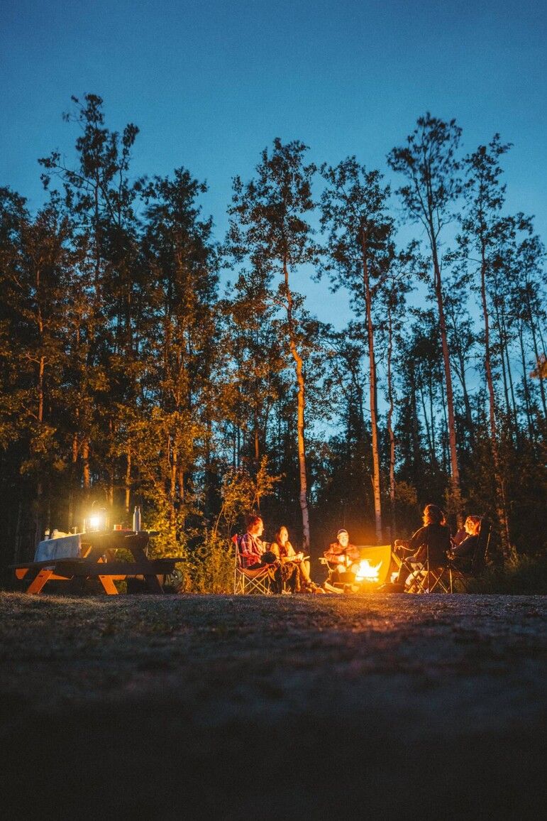 Gwillim Lake Park. Campfires bring people together as stories are shared under a clear evening sky and the glow of the flames lights up the night. Courtesy of Destination BC