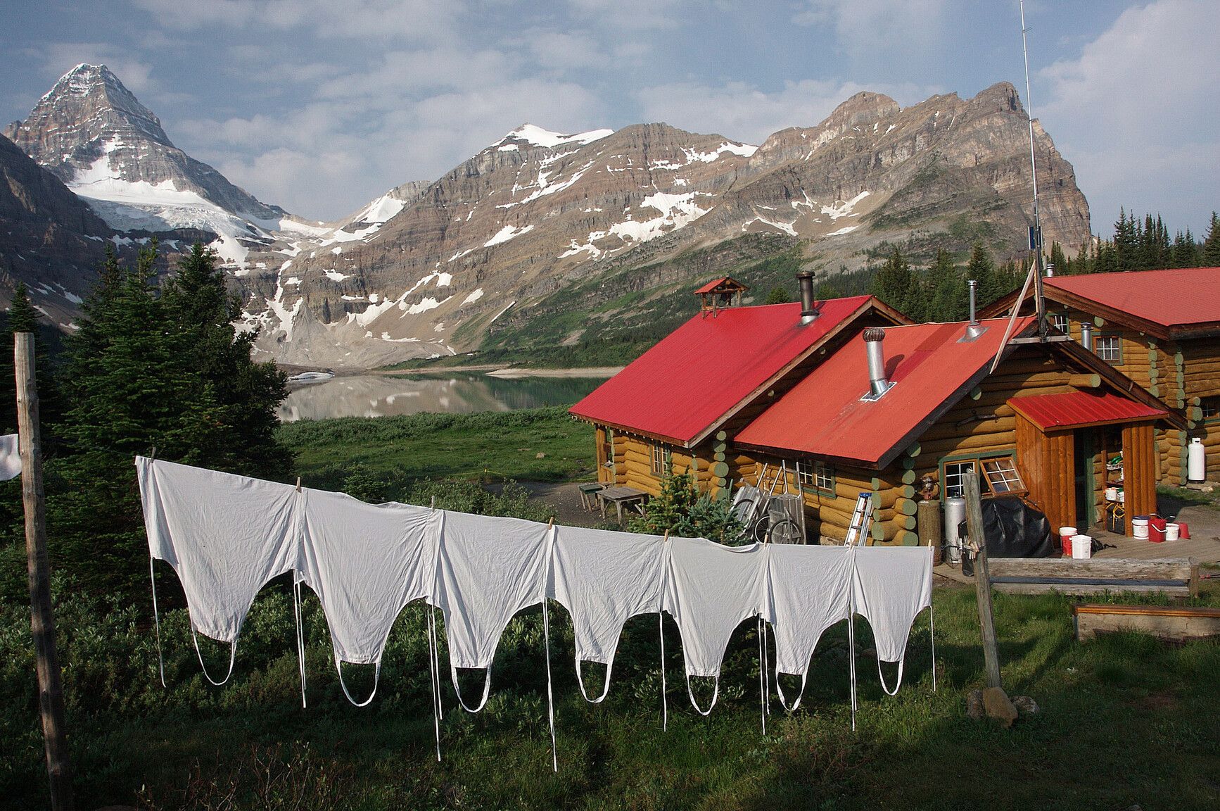 Assiniboine Lodge was built in 1928 and is recognized as North America's first back country ski lodge. It rests in a glacial valley surrounded by alpine meadows and peaks, reflecting the park's rich glacial history and remote beauty.