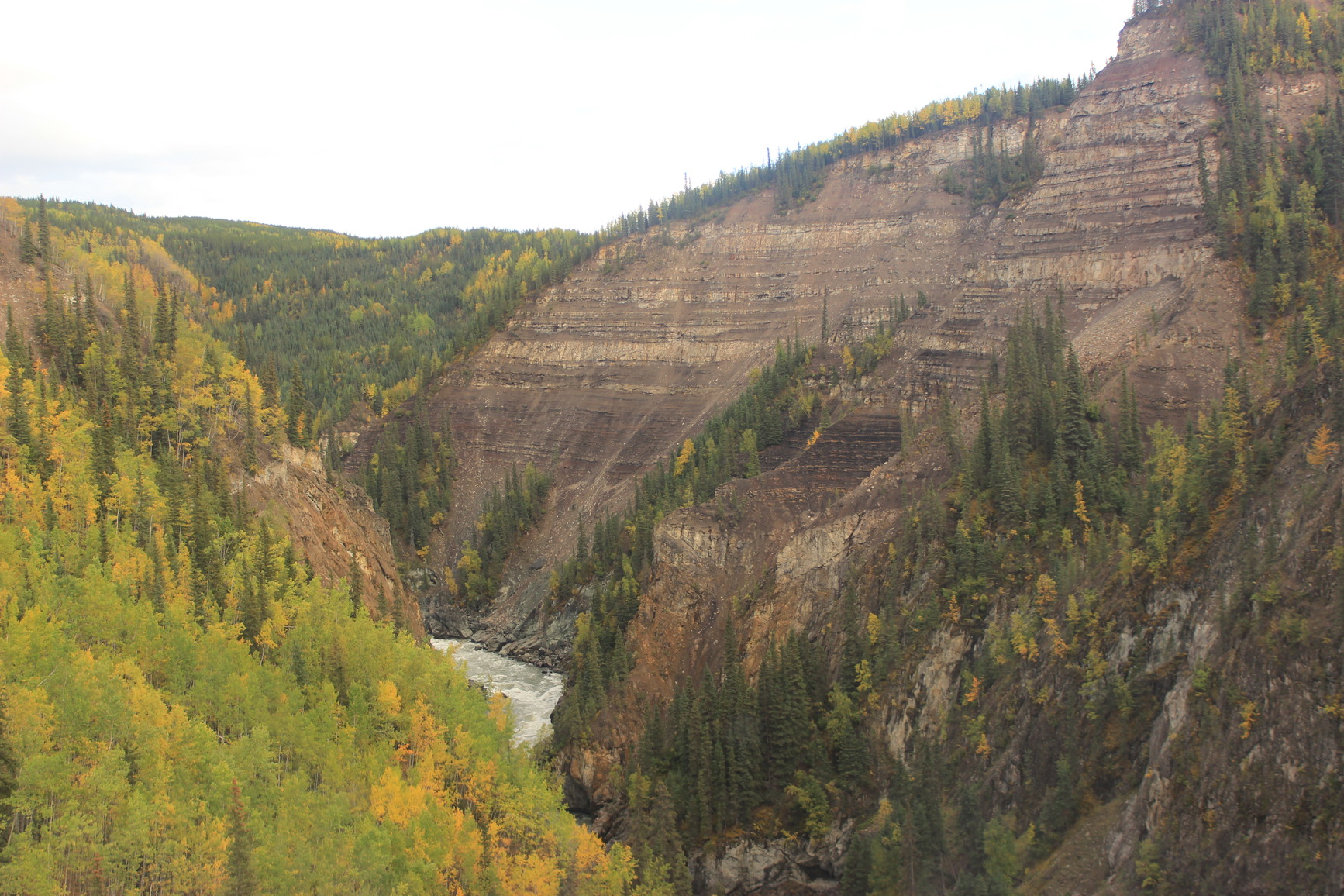 Overlooking the steep-walled canyon, composed of sedimentary and volcanic rock