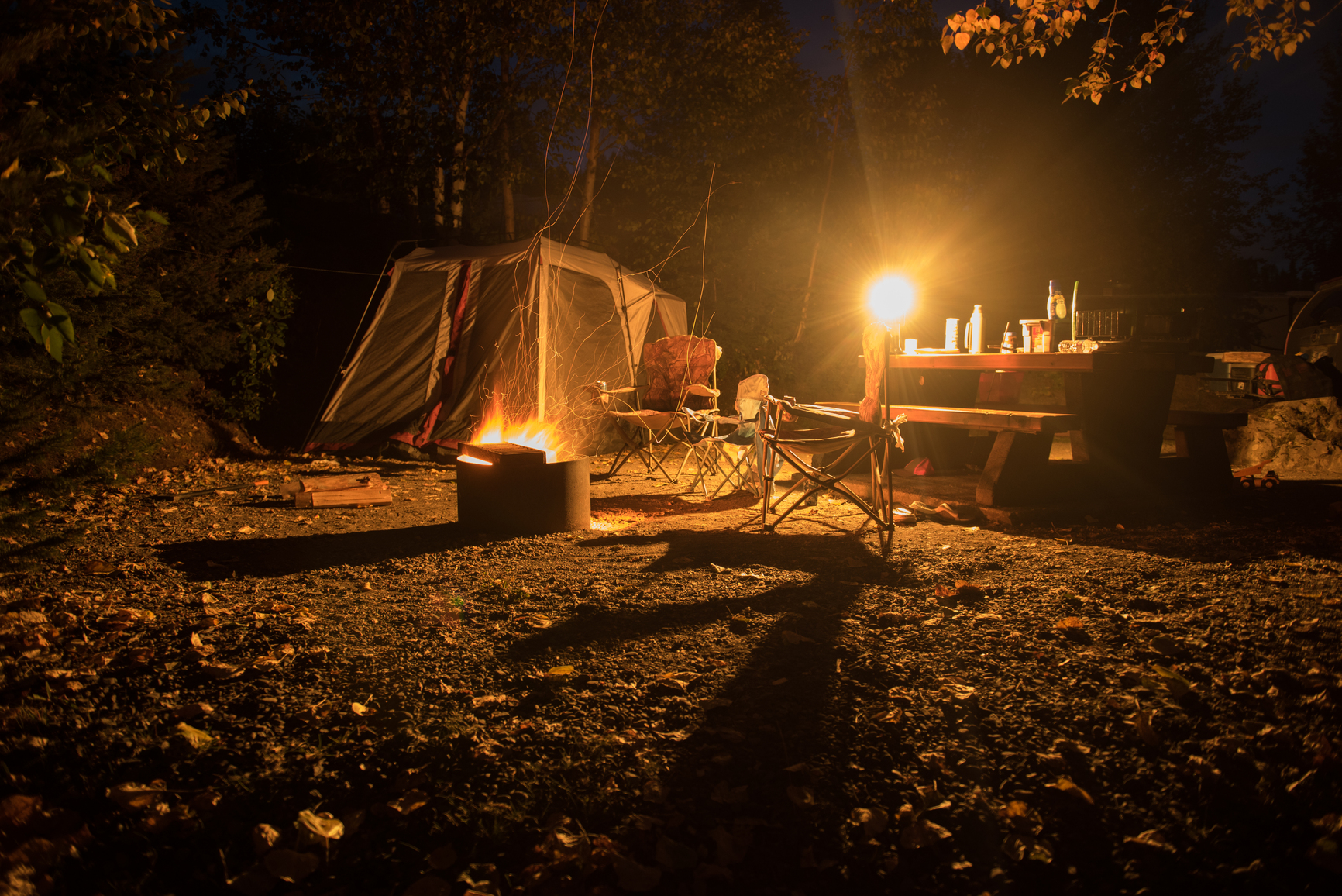 Campsite at night with a camp fire.