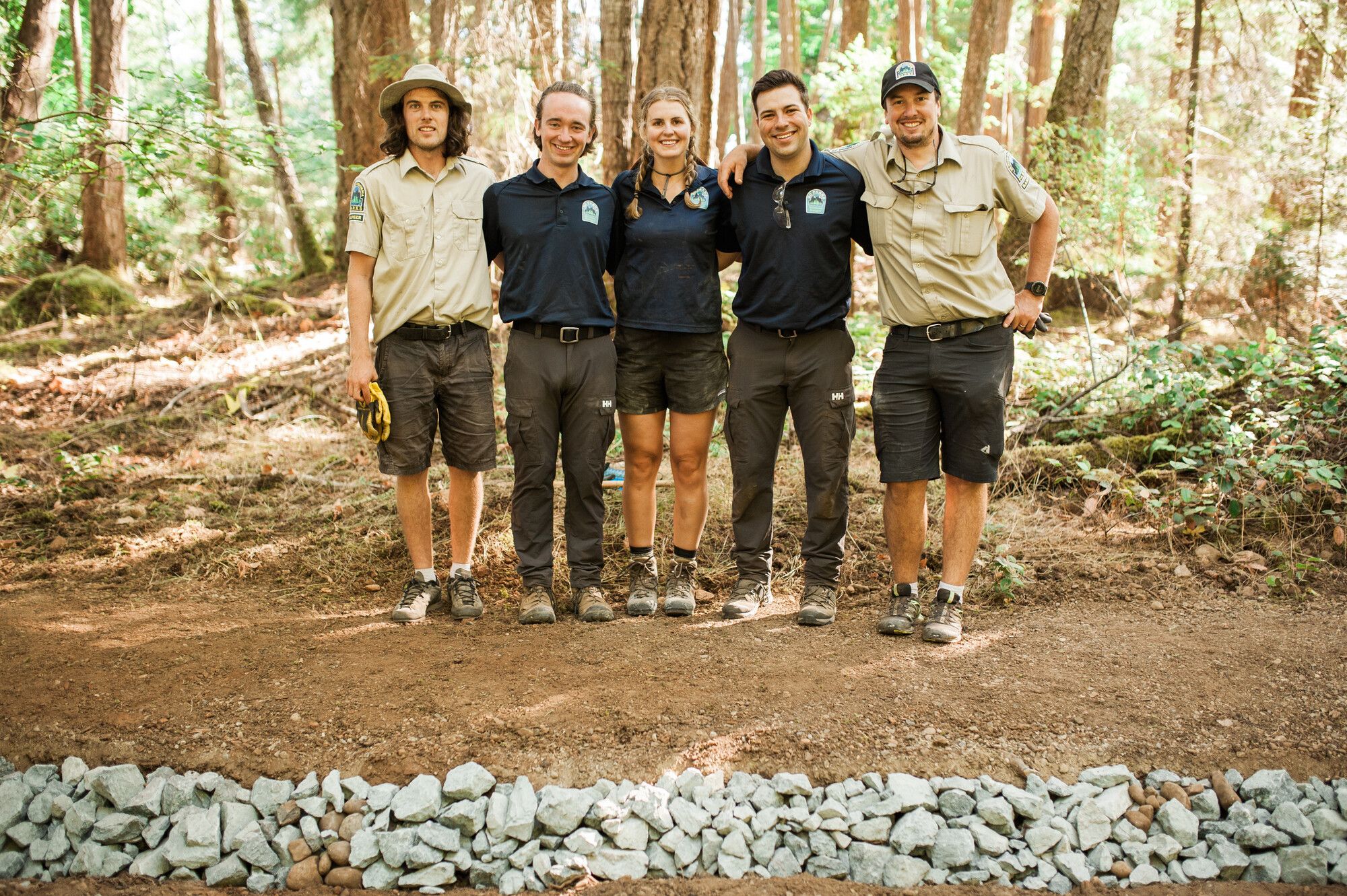 Park rangers and student rangers working on trail upgrades in Boyle Point Park, pause for a photo.