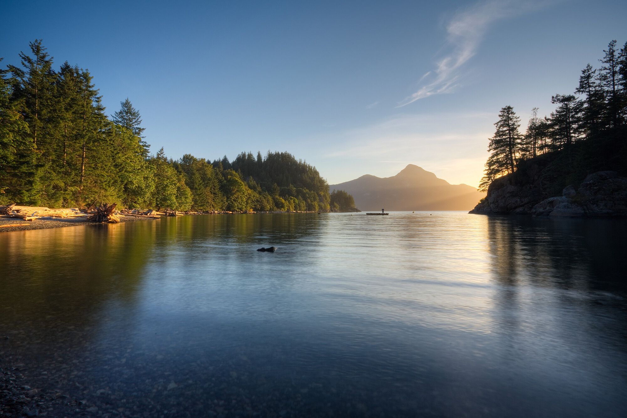 Calm water in the bay at sunset. Porteau Cove Park.