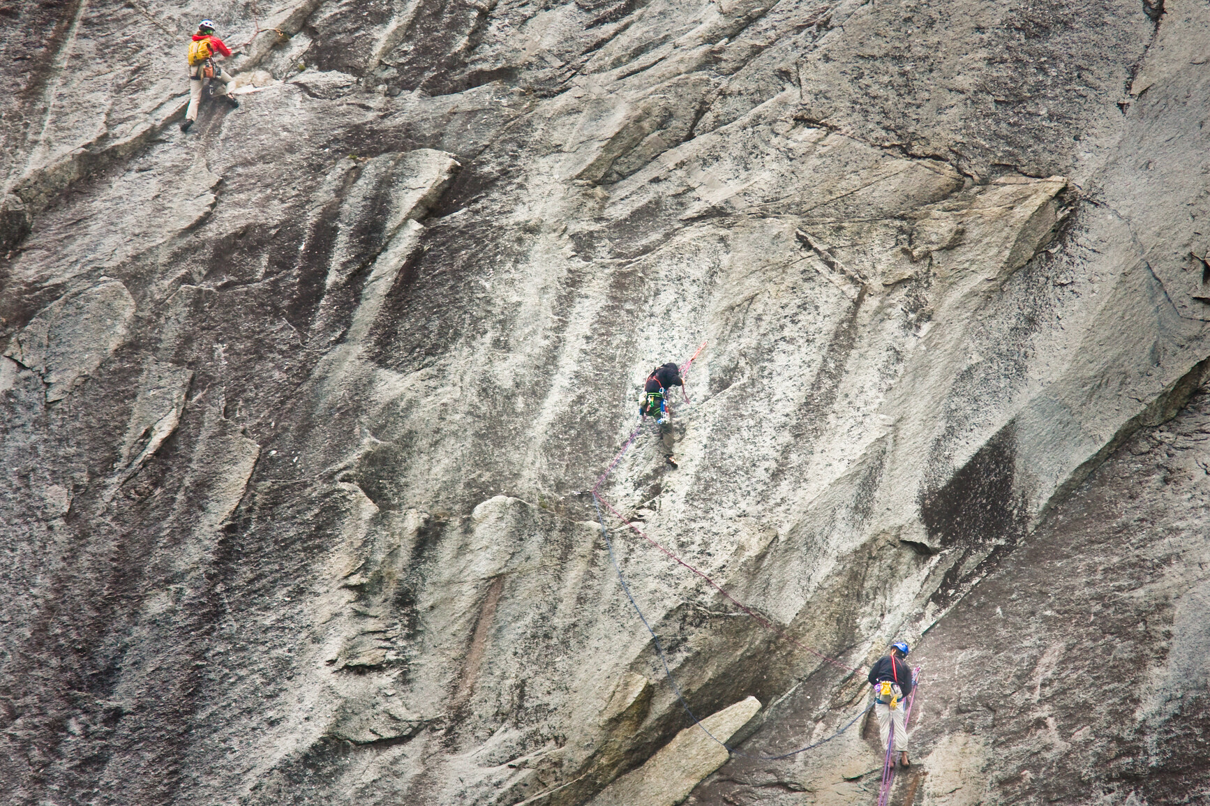 Climbers scaling the face of mountain.