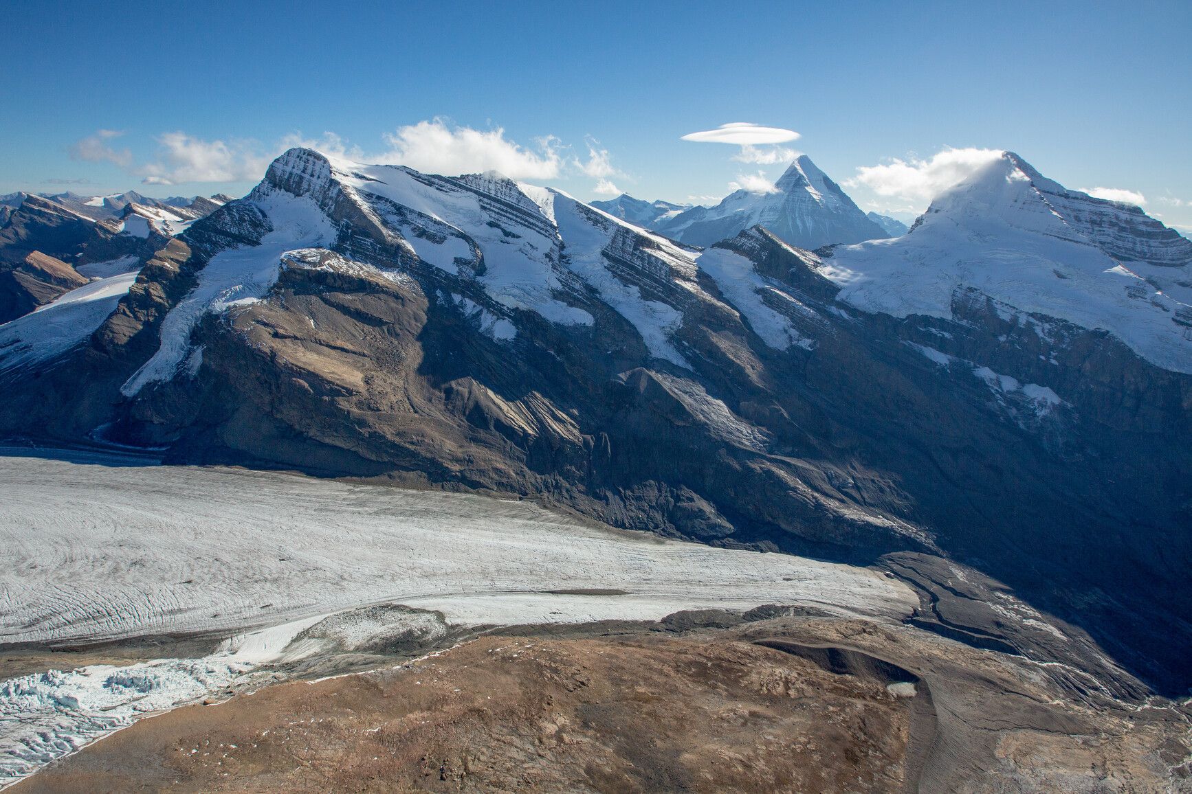 An aerial view of Swiftcurrent glacier on the north face of Whitehorn Mountain. Its retreat since 1986 has led to the formation of a new alpine lake which is below the view of this photo. Mount Robson Park.