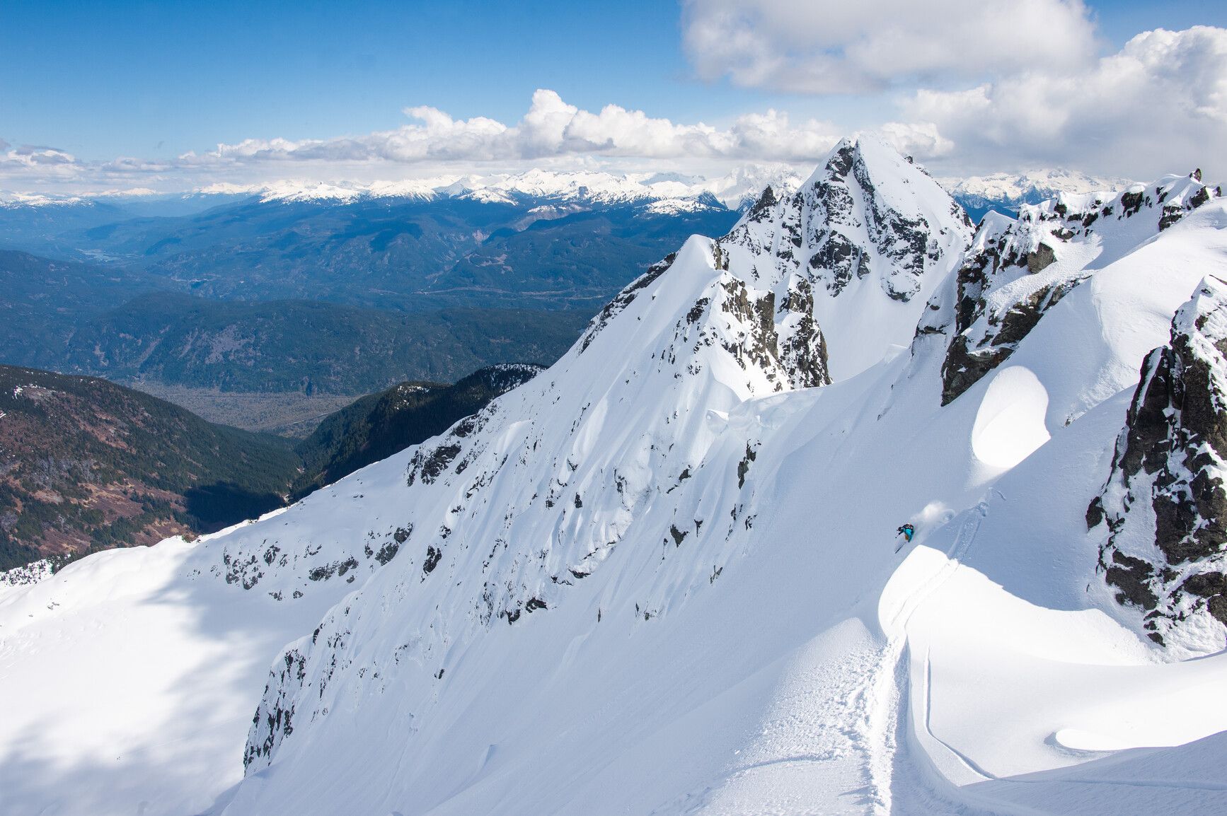 A backcountry skier on the face of a mountain. Tantalus Park.