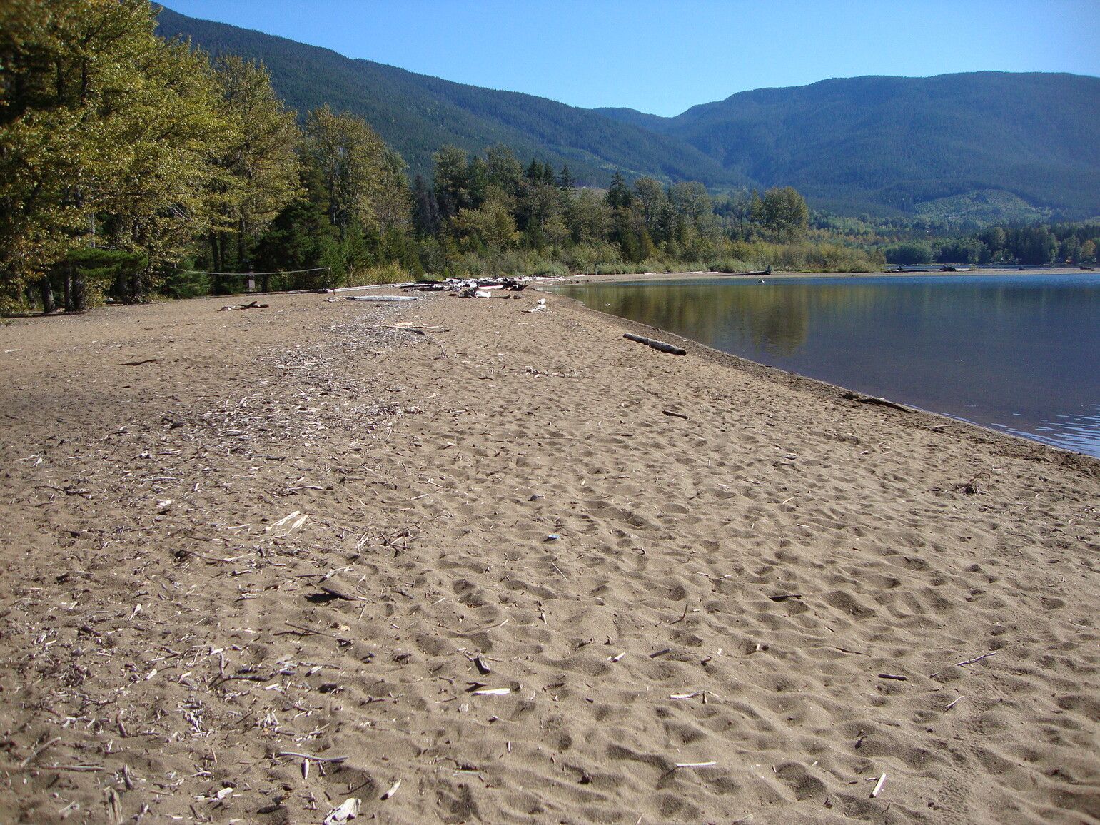 The sandy beach and a volleyball net await visitors. Gruchy's Beach, Lakelse Lake Park.