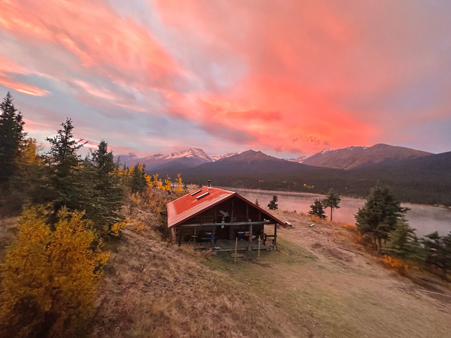 Autumn sunrise over the mountains in Spatsizi Plateau Wilderness Park. The cook house is located by Cold Fish Lake camp.