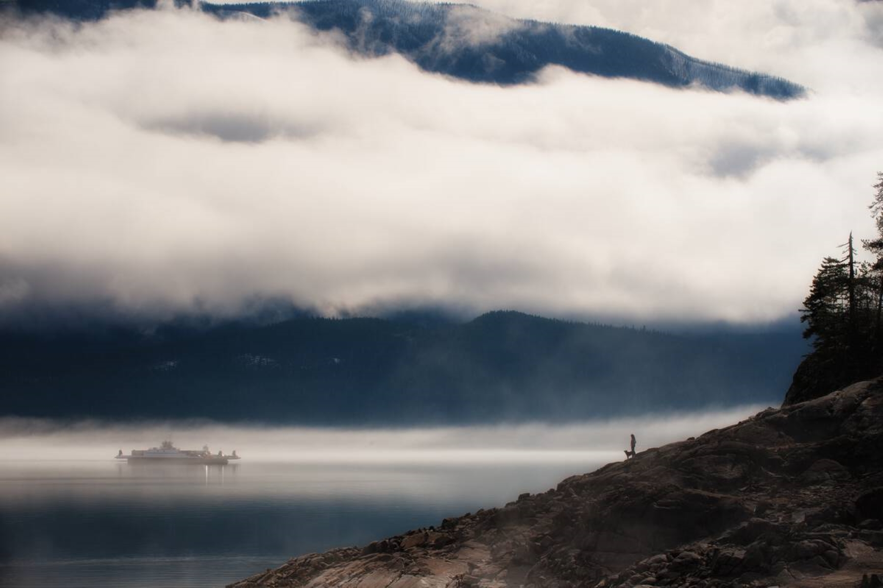 Arrow Lake in the foggy distance, from a mountain top view. Photo credit: Destination BC