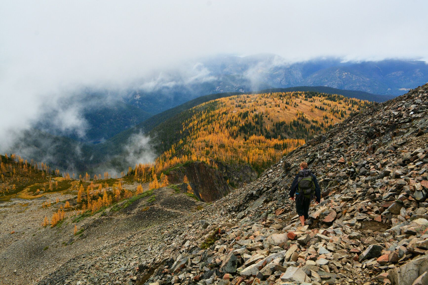 Hike Mount Frosty Trail, E.C. Manning Park, where frost-weathered rocks, golden larches, and forest-covered mountains create a stunning alpine landscape.