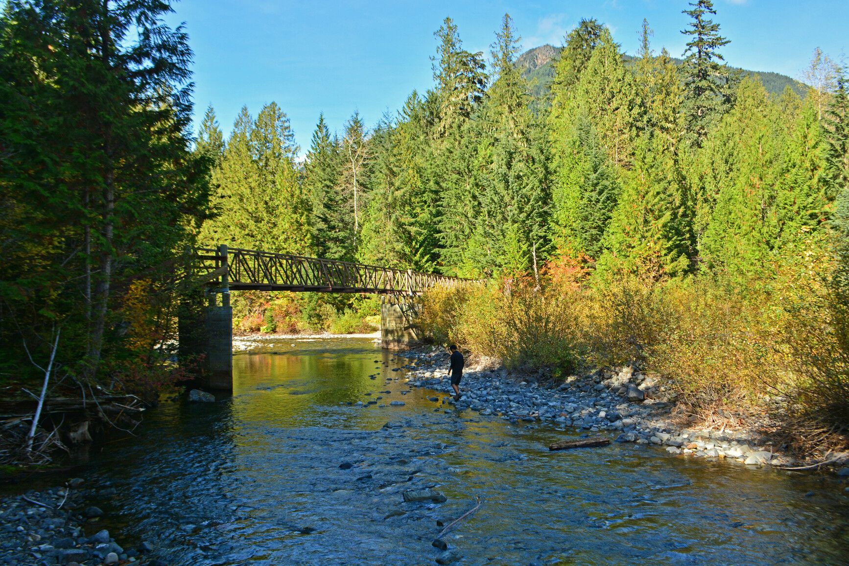 A park visitor explores the rocky banks of the Skagit River in E.C. Manning Park.