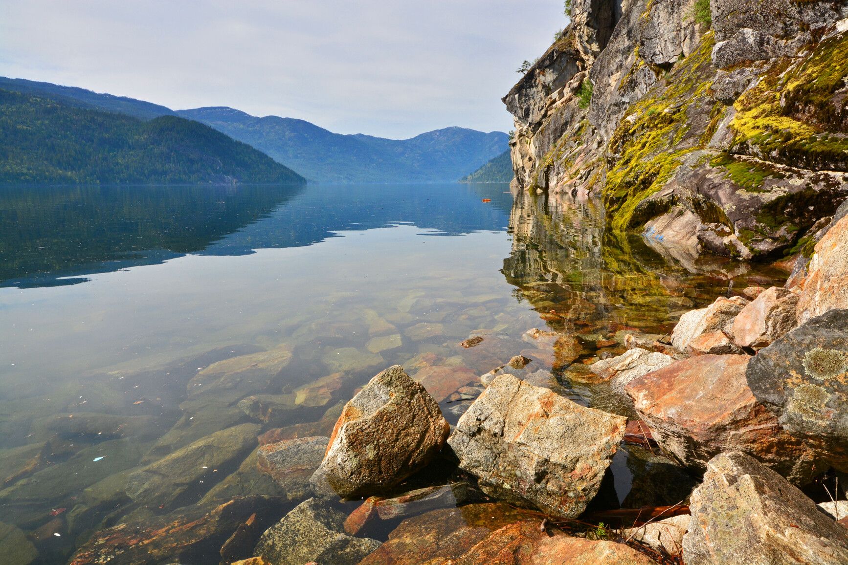 In Gladstone Park, a rocky shoreline provides a stunning view of the clear waters of Christina Lake.