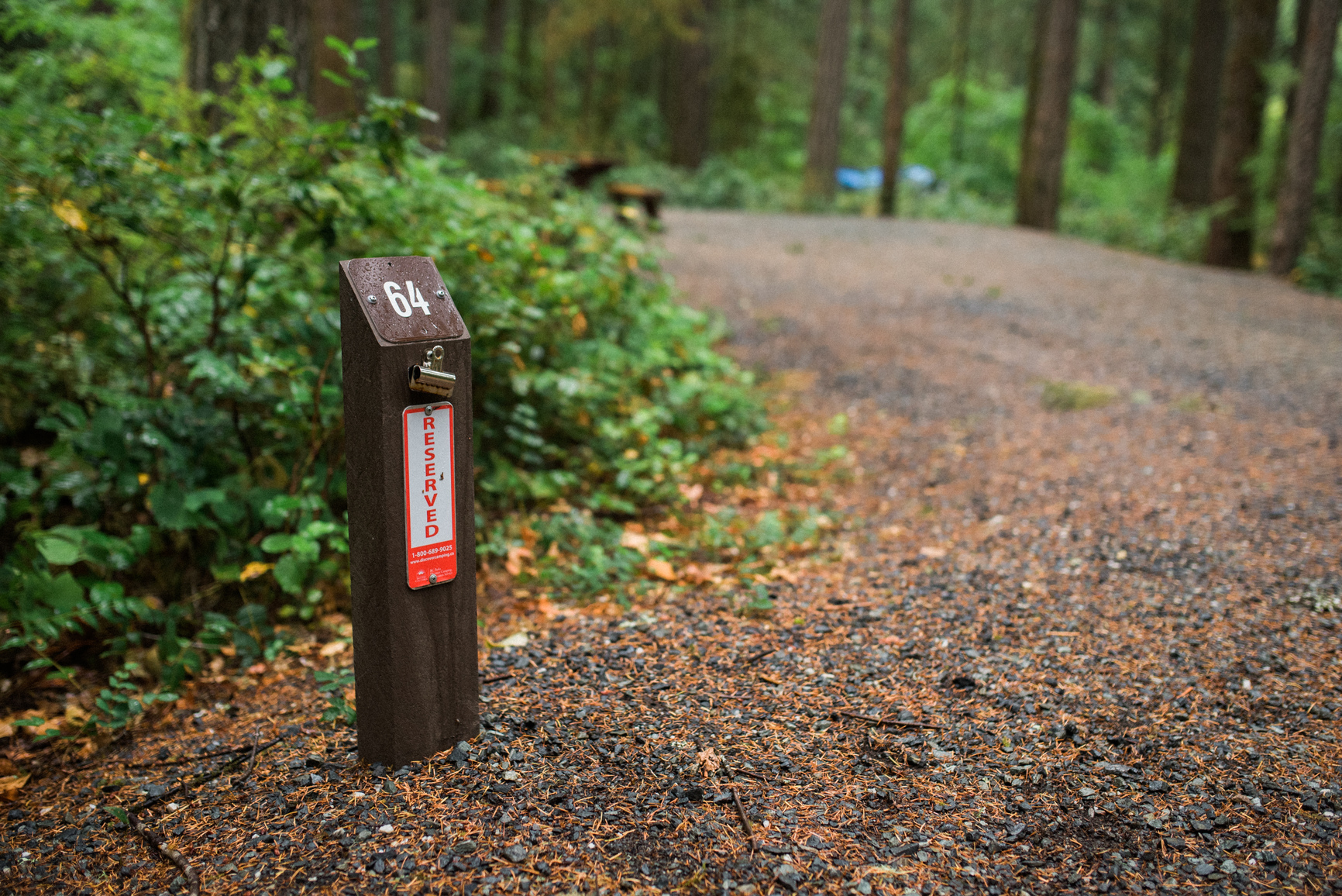 The signpost of campsite 54 with a reserved sticker