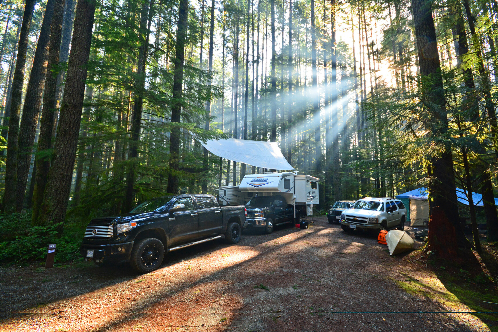 Campsite with rv's and vehicles.