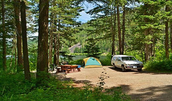 A truck and tent in a lakeside campsite at Otter Lake Park