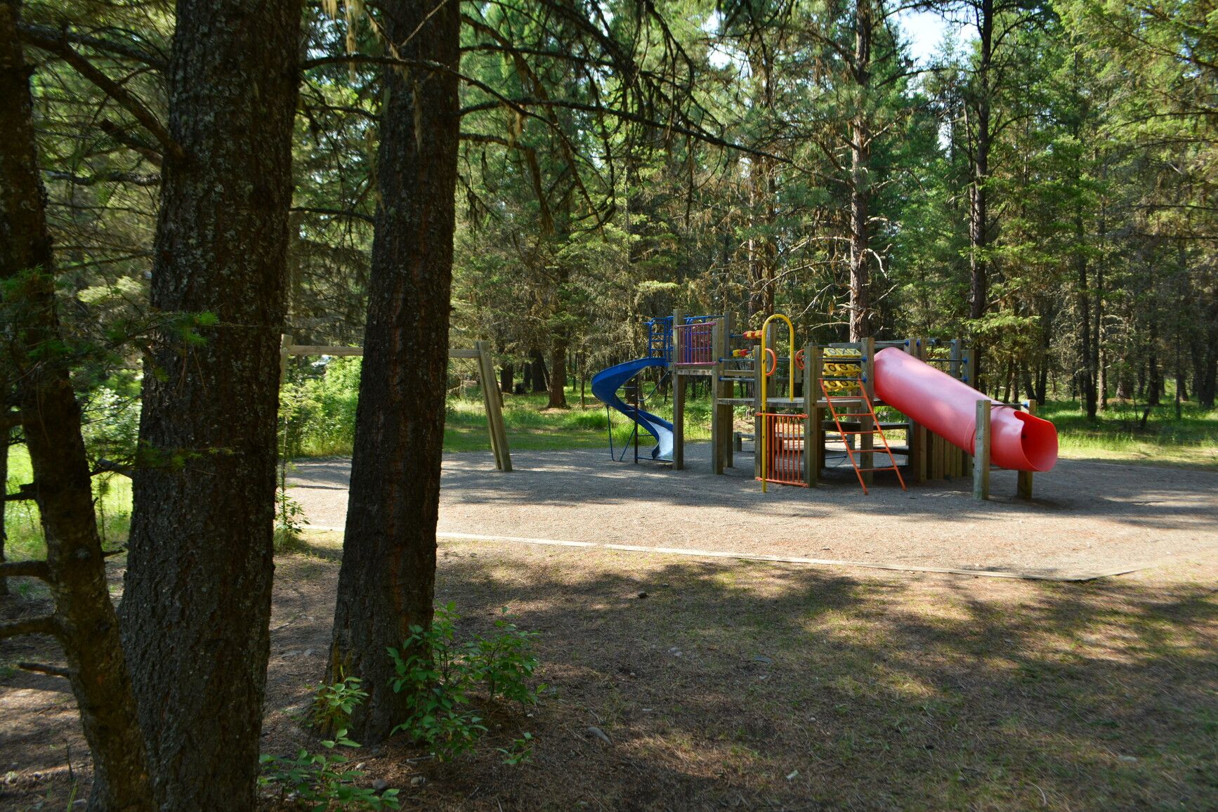 Explore Kikomun Creek Park's tranquil playground nestled among the trees.