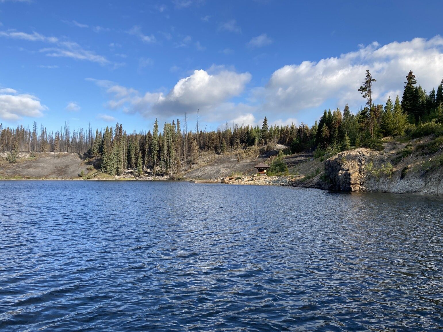 Little Andrews Bay shoreline and dock following the 2023 wildfire.