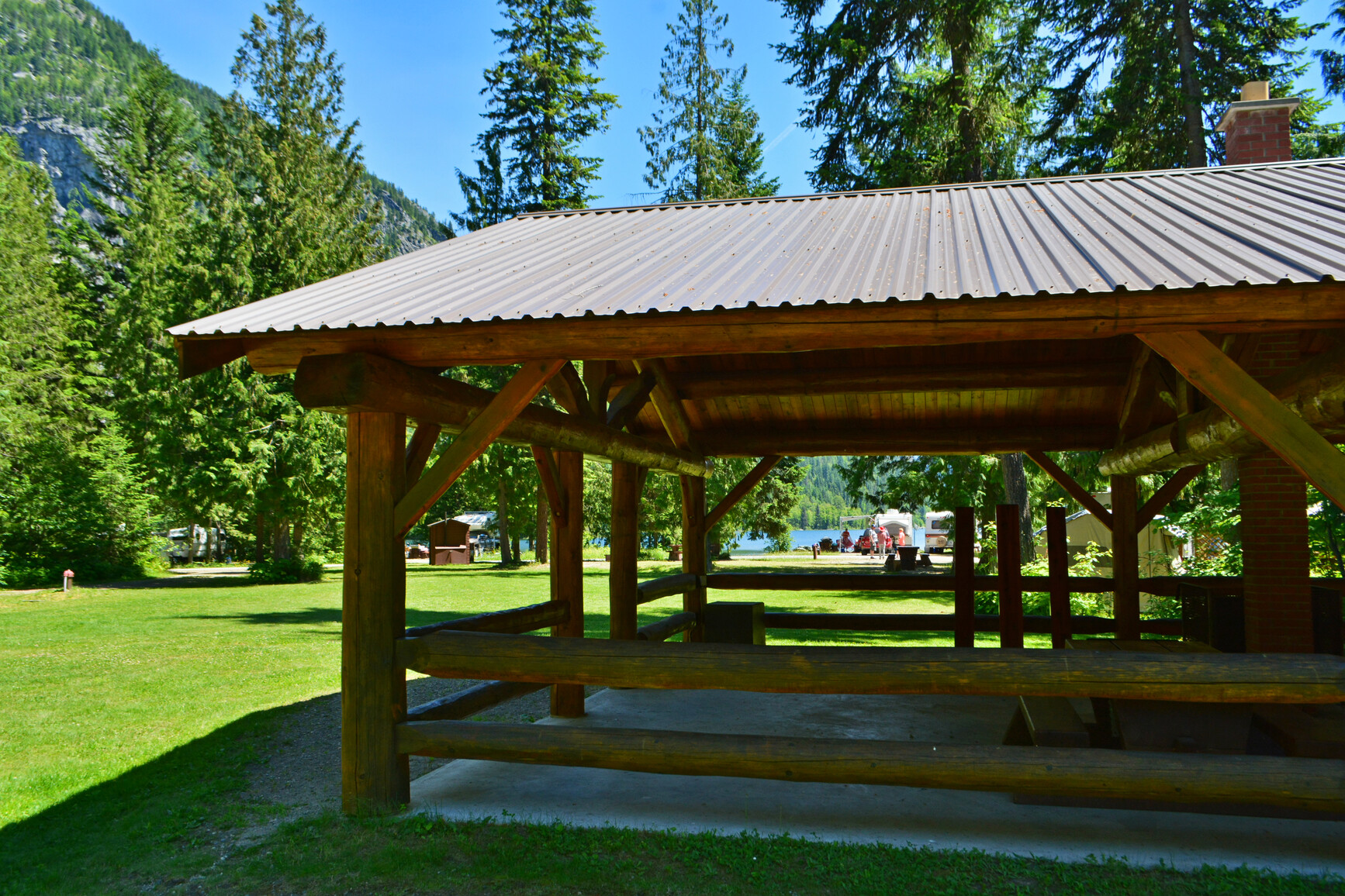 The picnic shelter at Summit Lake campground. The lake and mountains are in the background.