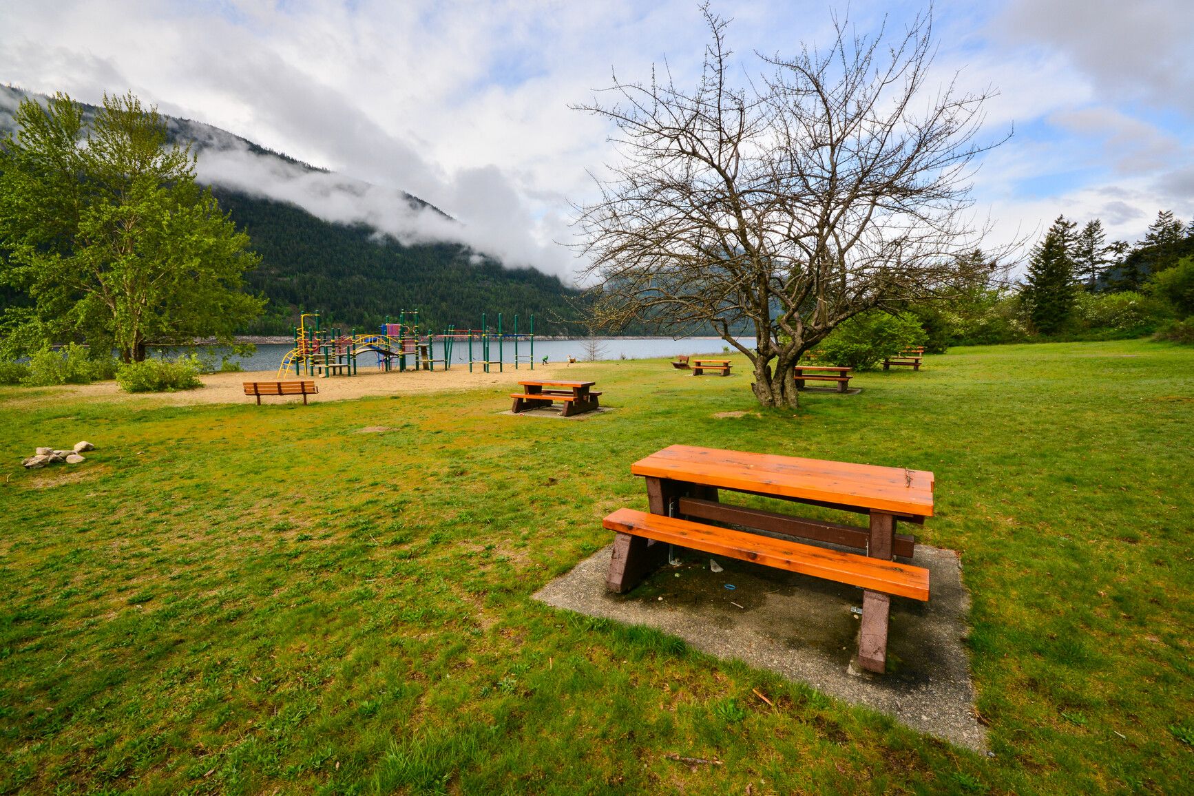 The day-use area at Syringa Park features a playground, views of Lower Arrow Lake, and forested mountains.
