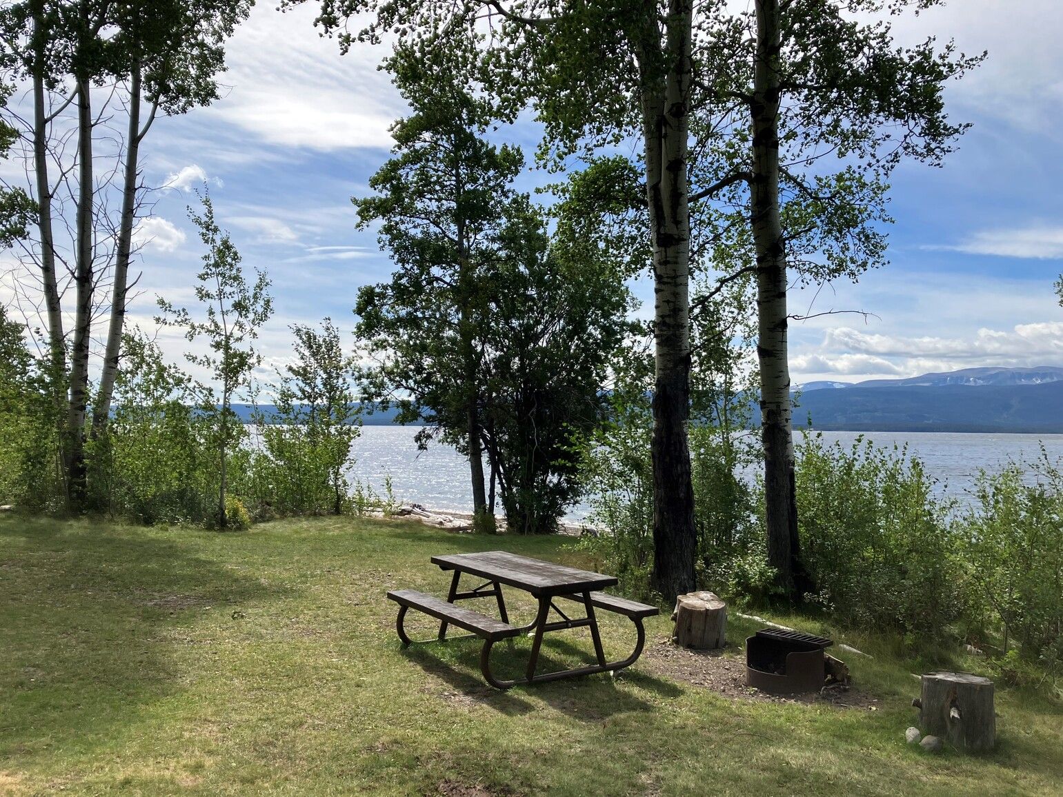 A lakeside campsite with a view of Ootsa Lake and the surrounding mountains. Wistaria Park.